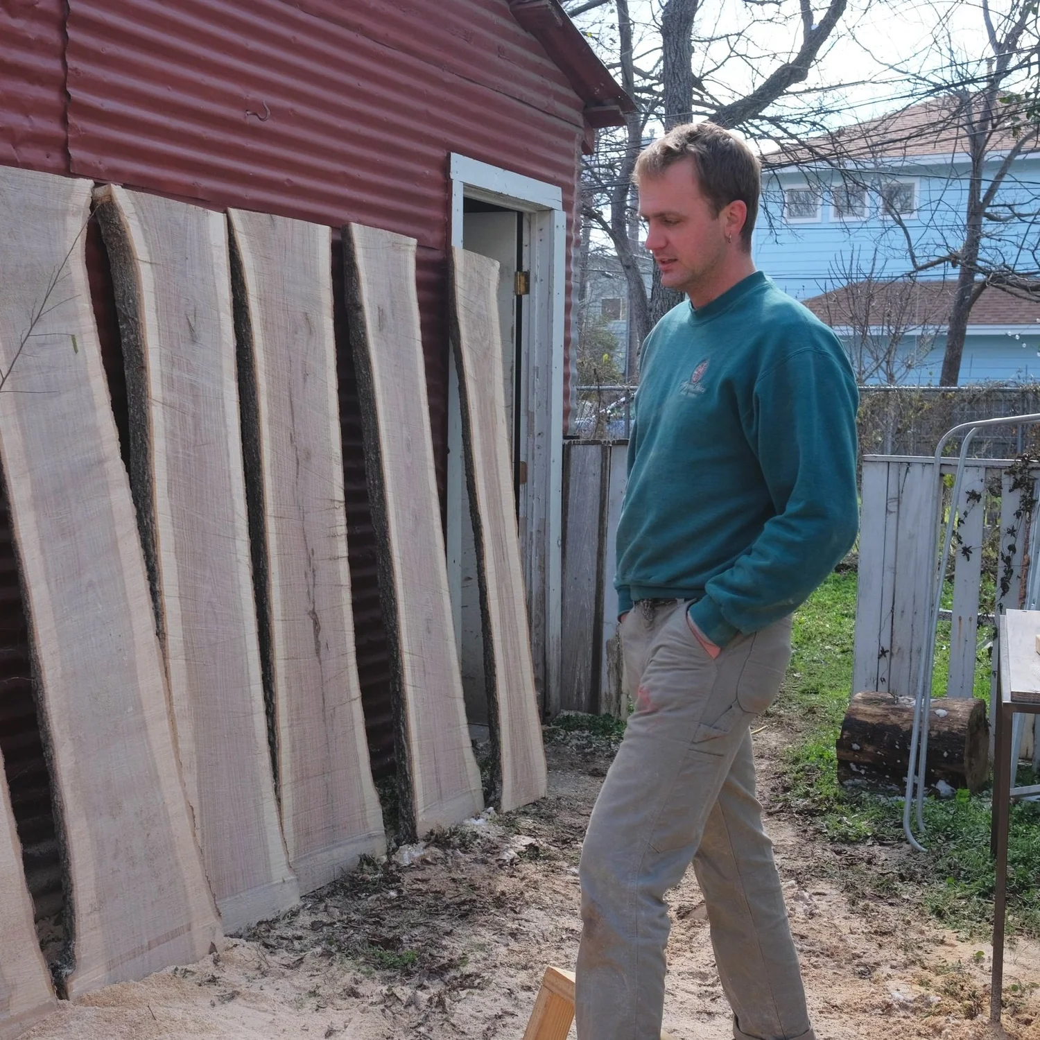 Charlie standing beside freshly milled local wood slabs