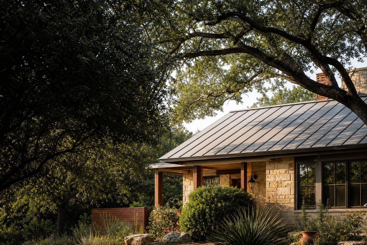 Live oak canopy with thoughtful clearance above a Central Texas limestone home